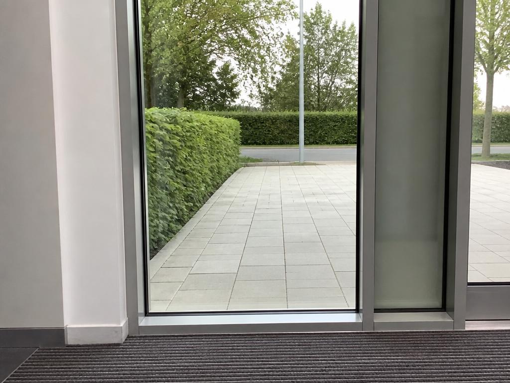 The same glass entrance panel from the same angle, now clear with no streaks or fingerprints